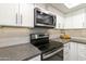 Modern kitchen with stainless steel appliances and white cabinets at 7756 E Coralbell Ave, Mesa, AZ 85208