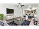 Bright, open living room with modern furnishings, decorative rug, and seamless flow into the adjacent dining area and kitchen at 7777 E Main St # 228, Scottsdale, AZ 85251