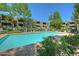 Community pool surrounded by lush landscaping at 7777 E Main St # 228, Scottsdale, AZ 85251