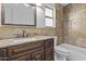 Bathroom features a dark wood vanity with granite countertops at 7804 W Pershing Ave, Peoria, AZ 85381