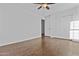 Bright bedroom featuring wood floors, a ceiling fan, and a closet for optimal storage at 7804 W Pershing Ave, Peoria, AZ 85381