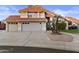 Charming two-story home featuring a three-car garage, red tile roof, and mature landscaping at 7804 W Pershing Ave, Peoria, AZ 85381