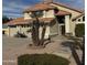 Well-maintained two-story home with a terracotta tile roof, a three-car garage, and desert landscaping at 7804 W Pershing Ave, Peoria, AZ 85381