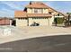 Charming home featuring a terracotta tile roof, three car garage, and neatly maintained landscaping at 7804 W Pershing Ave, Peoria, AZ 85381