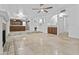 Open living room featuring tile floors, fireplace, and seamless access to kitchen and wet bar at 7804 W Pershing Ave, Peoria, AZ 85381