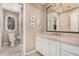 Bathroom features a neutral palette, toilet and white vanity with an ornate mirror at 7878 E Gainey Ranch Rd # 41, Scottsdale, AZ 85258