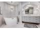 Modern bathroom featuring a soaking tub, a vanity with drawers and a arched mirror at 7878 E Gainey Ranch Rd # 41, Scottsdale, AZ 85258