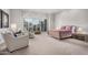 Spacious bedroom featuring a seating area and sliding door to the exterior at 7878 E Gainey Ranch Rd # 41, Scottsdale, AZ 85258