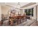 Elegant dining room with a large wood table, chandelier lighting, and a picturesque window view at 7878 E Gainey Ranch Rd # 41, Scottsdale, AZ 85258