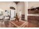 Grand foyer with high ceilings, hardwood floors, elegant lighting, and a stylish bar area at 7878 E Gainey Ranch Rd # 41, Scottsdale, AZ 85258