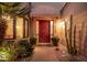 Inviting front entrance with a red door, decorative plants, and stylish lighting at 7878 E Gainey Ranch Rd # 41, Scottsdale, AZ 85258