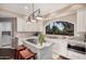 Bright kitchen featuring a center island cooktop and a large arched window at 7878 E Gainey Ranch Rd # 41, Scottsdale, AZ 85258