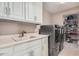 Bright laundry room featuring modern washer and dryer and built-in storage and shelving at 7878 E Gainey Ranch Rd # 41, Scottsdale, AZ 85258