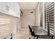 Office space featuring a large window with plantation shutters, cabinet storage and a neutral color palette at 7878 E Gainey Ranch Rd # 41, Scottsdale, AZ 85258