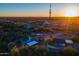 Aerial view of a property with multiple buildings, desert landscape, and a setting sun at 831 N Arroya Rd, Apache Junction, AZ 85119