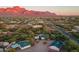 Aerial view showing two houses nestled in a desert landscape with mountain backdrop at 831 N Arroya Rd, Apache Junction, AZ 85119