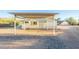 Front view of house with carport and gravel driveway at 831 N Arroya Rd, Apache Junction, AZ 85119