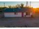 Pink single story home with a gray roof, two windows, and a pink door at 831 N Arroya Rd, Apache Junction, AZ 85119