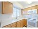 Kitchen features white appliances and wood cabinets at 831 N Arroya Rd, Apache Junction, AZ 85119