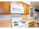 White appliances and wood cabinets in this efficient kitchen at 831 N Arroya Rd, Apache Junction, AZ 85119