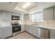 Modern kitchen with stainless steel appliances and gray cabinets at 831 N Arroya Rd, Apache Junction, AZ 85119