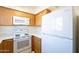 Galley kitchen with white appliances and wood cabinets at 831 N Arroya Rd, Apache Junction, AZ 85119