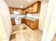 Cozy kitchen featuring wooden cabinets, modern appliances, and tile floors at 831 N Arroya Rd, Apache Junction, AZ 85119