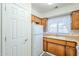 White refrigerator and wood cabinets in this galley-style kitchen at 831 N Arroya Rd, Apache Junction, AZ 85119