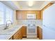 Kitchen with white appliances and wood cabinets at 831 N Arroya Rd, Apache Junction, AZ 85119