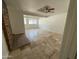 Spacious living room with stone flooring, brick fireplace and natural light from windows at 831 N Arroya Rd, Apache Junction, AZ 85119