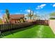 Artificial turf backyard with wooden fence and cacti at 8375 E Via Dona Rd, Scottsdale, AZ 85266