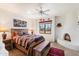 Bedroom with a wooden bed, fireplace and mountain views at 8375 E Via Dona Rd, Scottsdale, AZ 85266