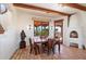 Cozy breakfast nook with a rustic table and built-in fireplace at 8375 E Via Dona Rd, Scottsdale, AZ 85266