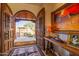 Open double doors reveal a grand entry with rustic charm at 8375 E Via Dona Rd, Scottsdale, AZ 85266