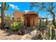 Charming stucco home with a wooden door and pathway at 8375 E Via Dona Rd, Scottsdale, AZ 85266