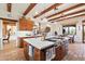 Bright kitchen with an island, wood cabinets, and terracotta tile floors at 8375 E Via Dona Rd, Scottsdale, AZ 85266