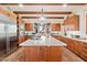 Gourmet kitchen with wood cabinetry, large island, and high-end appliances at 8375 E Via Dona Rd, Scottsdale, AZ 85266