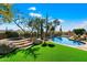 Luxury backyard oasis featuring a sparkling pool, spa, and lush landscaping at 8375 E Via Dona Rd, Scottsdale, AZ 85266