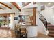 Custom wet bar with a curved design, nestled near a winding staircase at 8375 E Via Dona Rd, Scottsdale, AZ 85266