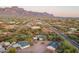 Aerial view showcasing a desert property with multiple buildings and surrounding landscape at 843 N Arroya Rd, Apache Junction, AZ 85119