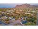 Aerial view of a property with multiple buildings, desert landscape and mountain backdrop at 843 N Arroya Rd, Apache Junction, AZ 85119