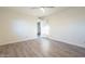 Well-lit bedroom with wood-look floors and door to hallway at 843 N Arroya Rd, Apache Junction, AZ 85119