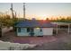 Single story house with brick patio, carport, and sunset view at 843 N Arroya Rd, Apache Junction, AZ 85119