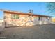 Rear exterior of the house, showcasing a simple yard at 843 N Arroya Rd, Apache Junction, AZ 85119