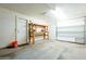 Garage interior with a workbench, door, and overhead door at 843 N Arroya Rd, Apache Junction, AZ 85119