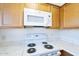 Kitchen features white appliances and light wood cabinets at 843 N Arroya Rd, Apache Junction, AZ 85119