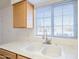 Kitchen with double sink, light wood cabinets, and window at 843 N Arroya Rd, Apache Junction, AZ 85119