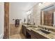 Bathroom with double sinks, granite countertop, and stone tile at 844 W Wagner Dr, Gilbert, AZ 85233