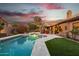 Relaxing pool area with artificial turf and a covered patio at 844 W Wagner Dr, Gilbert, AZ 85233