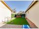 Spacious backyard with artificial turf, games, and seating area at 8520 W Palm Ln # 1049, Phoenix, AZ 85037